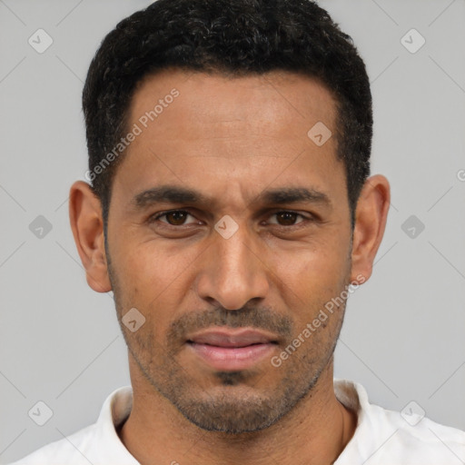 Joyful white young-adult male with short  black hair and brown eyes