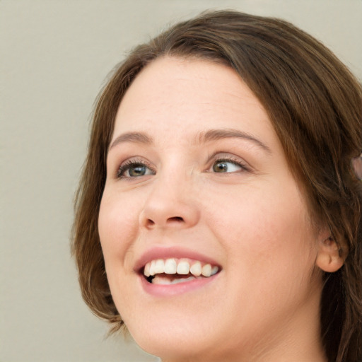 Joyful white young-adult female with medium  brown hair and green eyes