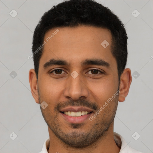 Joyful latino young-adult male with short  black hair and brown eyes