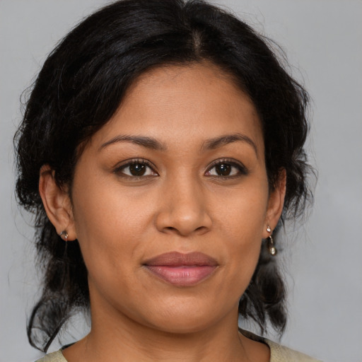 Joyful latino young-adult female with medium  brown hair and brown eyes