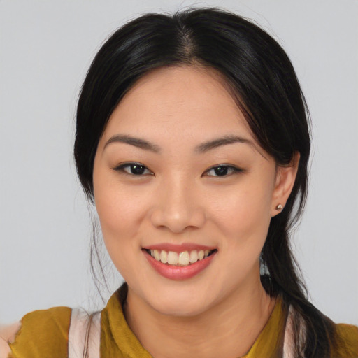 Joyful asian young-adult female with long  black hair and brown eyes