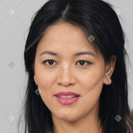 Joyful asian young-adult female with long  brown hair and brown eyes