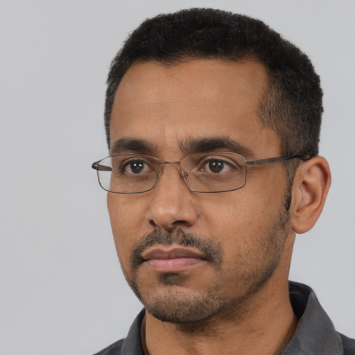 Neutral latino adult male with short  black hair and brown eyes