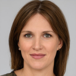 Joyful white adult female with medium  brown hair and grey eyes