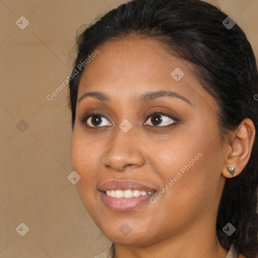 Joyful black young-adult female with long  brown hair and brown eyes