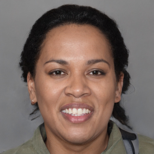 Joyful latino adult female with short  brown hair and brown eyes