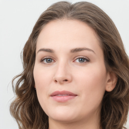 Joyful white young-adult female with long  brown hair and green eyes