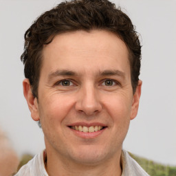 Joyful white adult male with short  brown hair and brown eyes