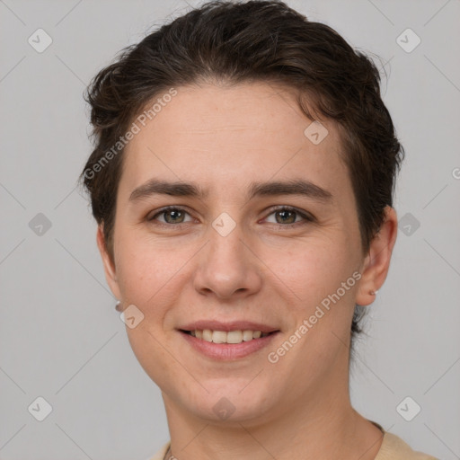 Joyful white young-adult female with short  brown hair and grey eyes