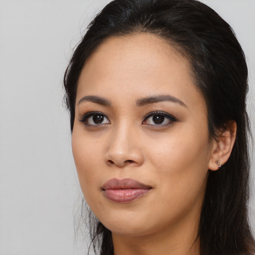 Joyful asian young-adult female with long  black hair and brown eyes