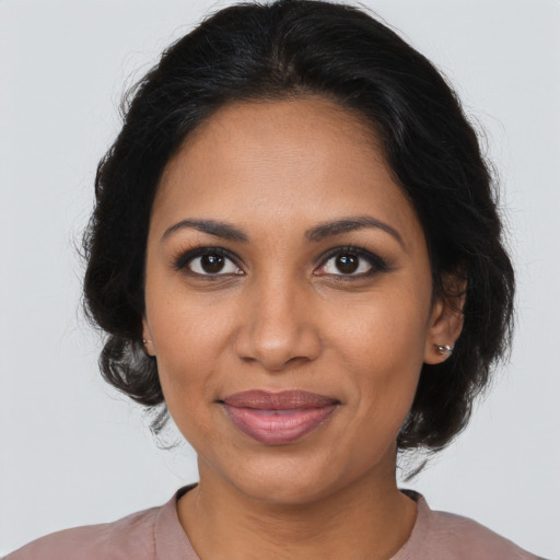 Joyful black young-adult female with medium  brown hair and brown eyes