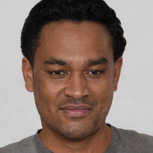 Neutral latino adult male with short  black hair and brown eyes