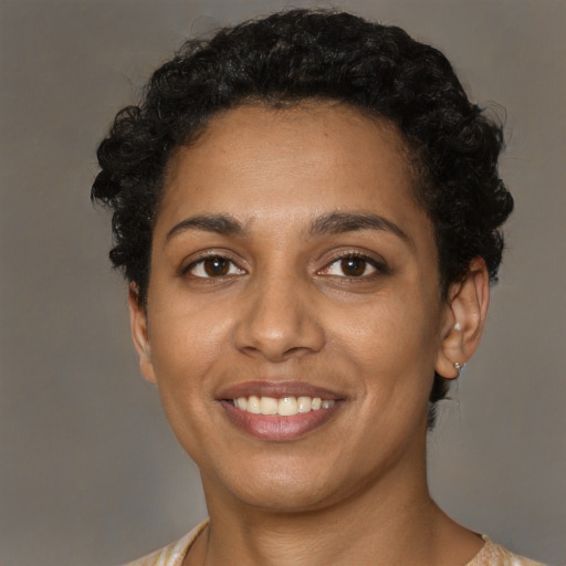 Joyful black young-adult female with short  brown hair and brown eyes