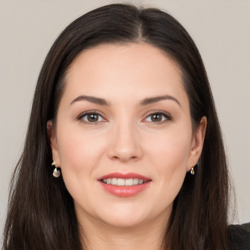 Joyful white young-adult female with long  brown hair and brown eyes