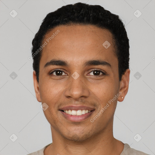 Joyful latino young-adult male with short  black hair and brown eyes