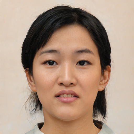 Joyful asian young-adult female with medium  black hair and brown eyes