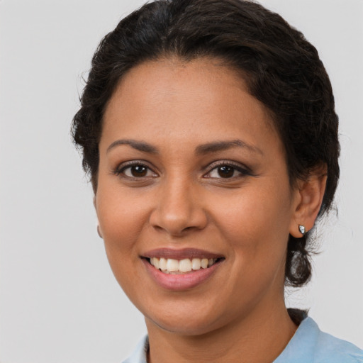 Joyful latino young-adult female with short  brown hair and brown eyes