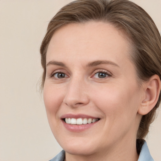 Joyful white young-adult female with medium  brown hair and grey eyes