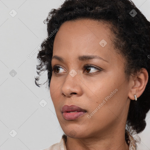 Joyful black young-adult female with medium  brown hair and brown eyes