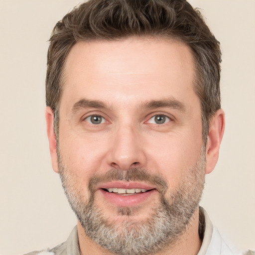 Joyful white adult male with short  brown hair and brown eyes