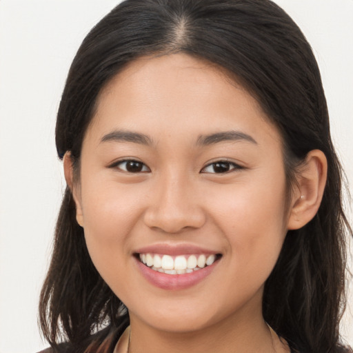 Joyful asian young-adult female with long  brown hair and brown eyes