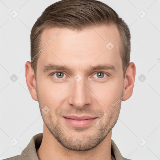 Joyful white young-adult male with short  brown hair and grey eyes