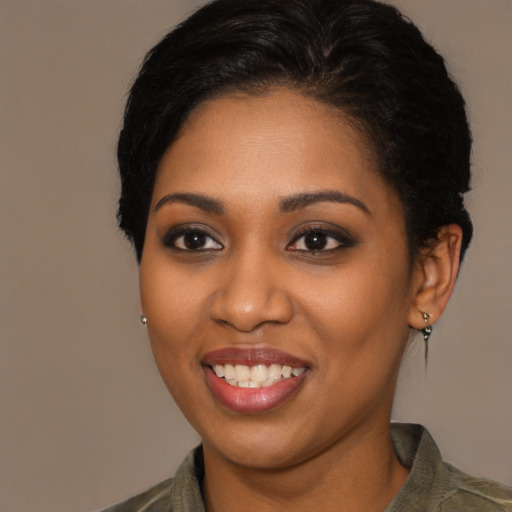 Joyful black young-adult female with short  brown hair and brown eyes