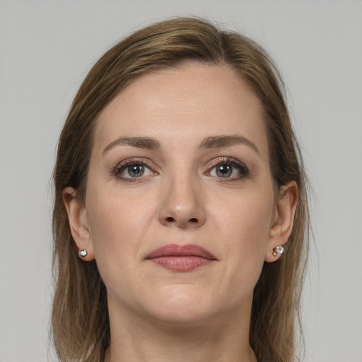 Joyful white young-adult female with medium  brown hair and grey eyes