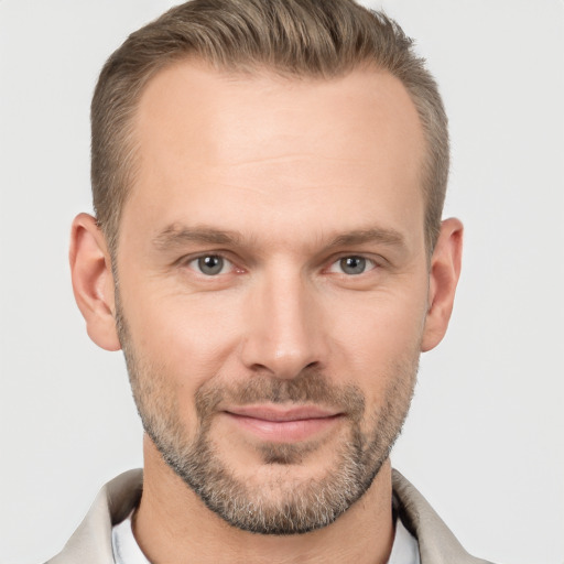 Joyful white adult male with short  brown hair and brown eyes