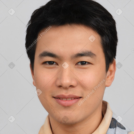 Joyful asian young-adult male with short  black hair and brown eyes