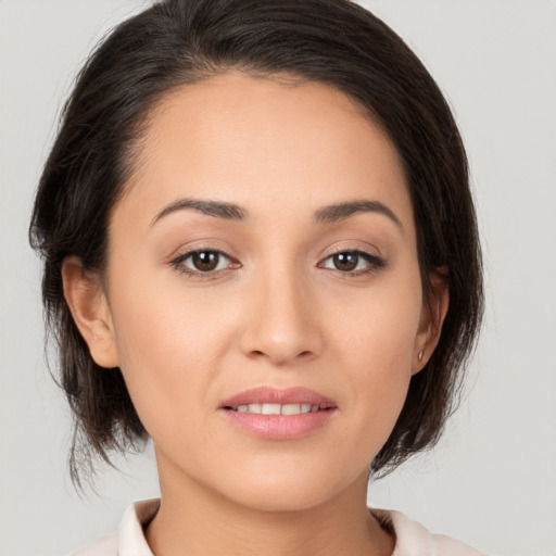 Joyful white young-adult female with medium  brown hair and brown eyes