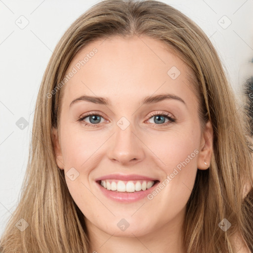 Joyful white young-adult female with long  brown hair and green eyes