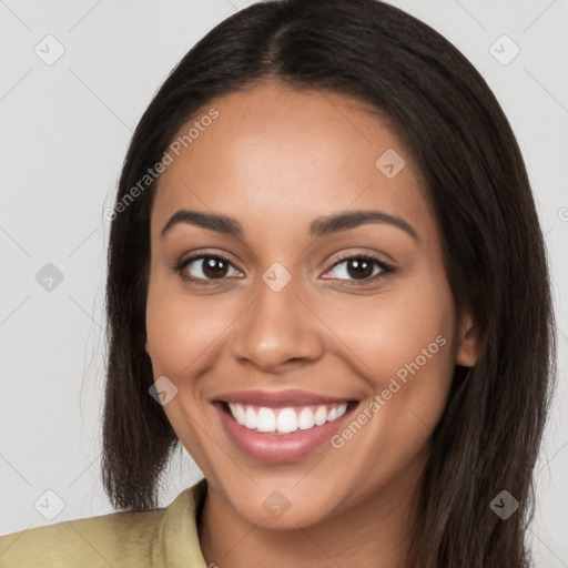 Joyful latino young-adult female with long  brown hair and brown eyes