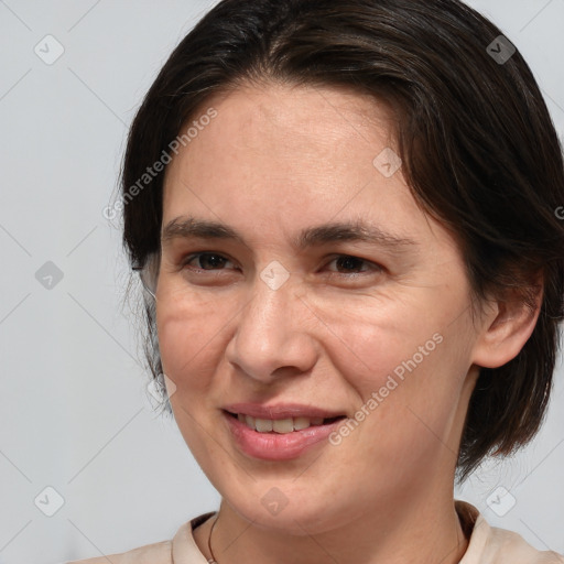 Joyful white adult female with medium  brown hair and brown eyes