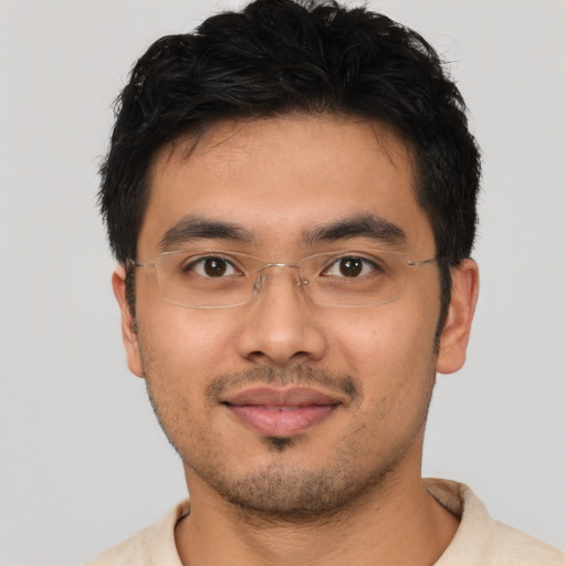 Joyful latino young-adult male with short  brown hair and brown eyes