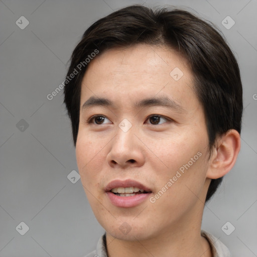 Joyful asian young-adult male with short  brown hair and brown eyes