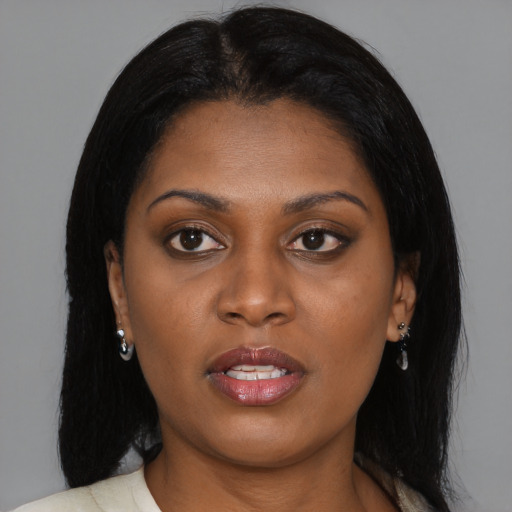 Joyful black young-adult female with medium  brown hair and brown eyes
