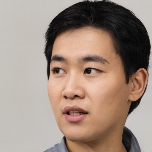 Neutral asian young-adult male with short  black hair and brown eyes