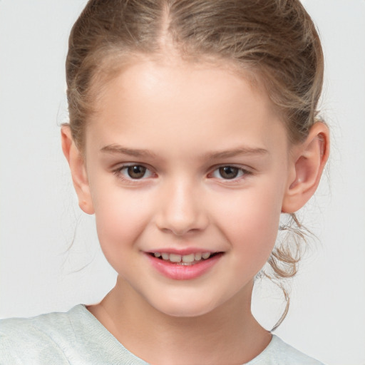 Joyful white child female with medium  brown hair and brown eyes