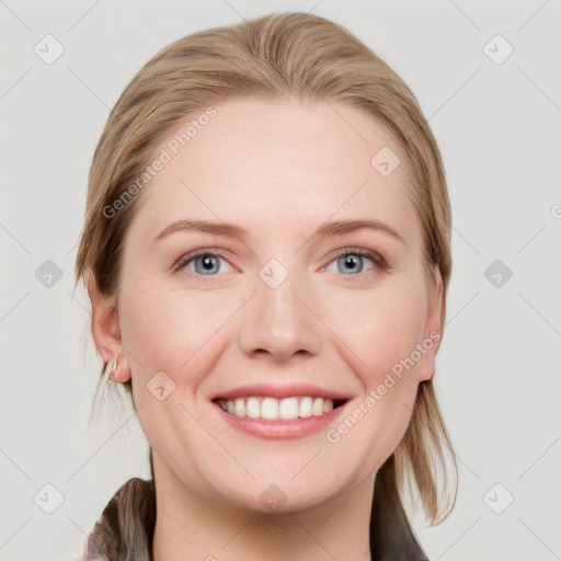 Joyful white young-adult female with medium  brown hair and blue eyes