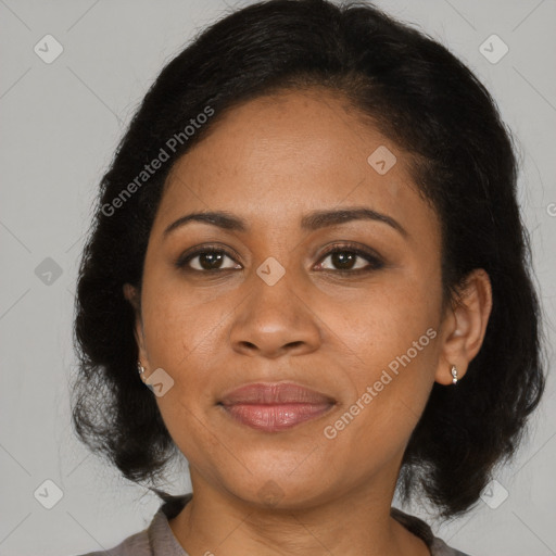 Joyful black adult female with medium  brown hair and brown eyes