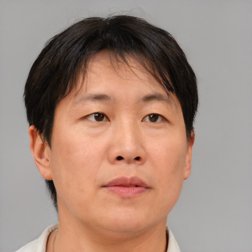 Neutral asian adult male with short  brown hair and brown eyes