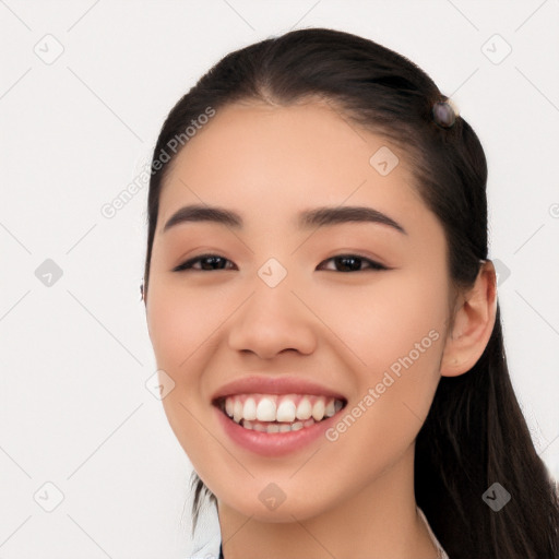 Joyful white young-adult female with long  black hair and brown eyes