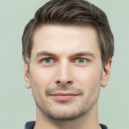 Joyful white young-adult male with short  brown hair and grey eyes