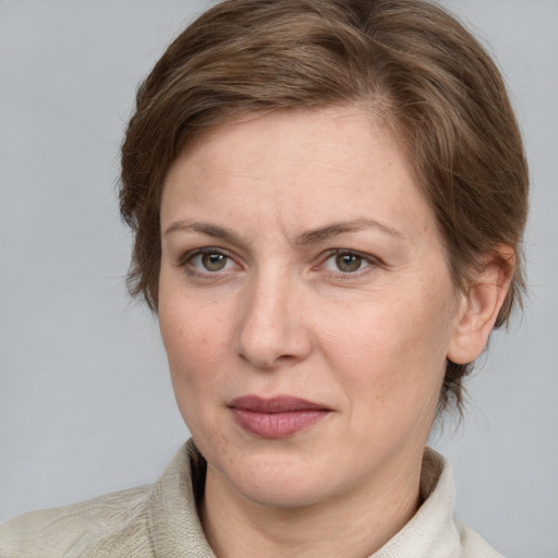 Joyful white adult female with medium  brown hair and grey eyes