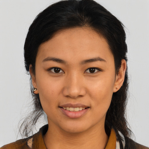 Joyful latino young-adult female with long  black hair and brown eyes