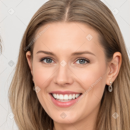 Joyful white young-adult female with long  brown hair and grey eyes