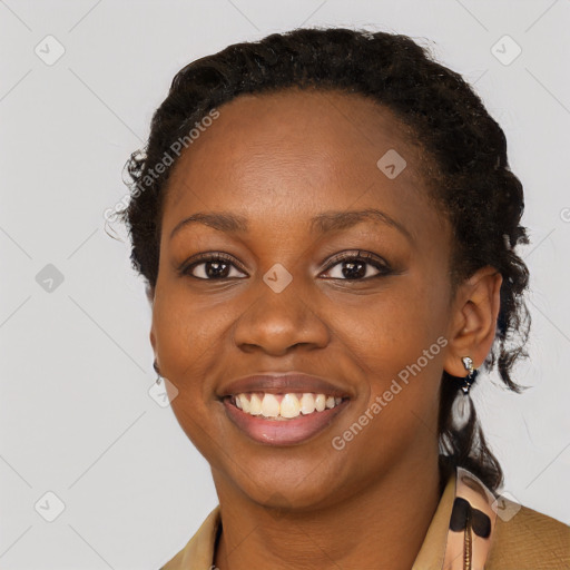 Joyful black young-adult female with short  brown hair and brown eyes