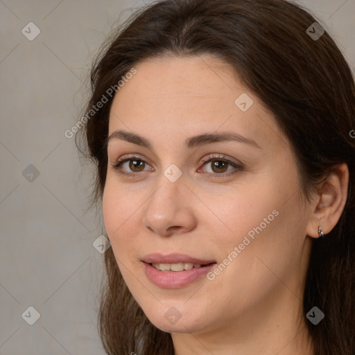 Joyful white young-adult female with long  brown hair and brown eyes