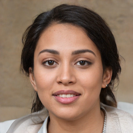 Joyful latino young-adult female with medium  black hair and brown eyes